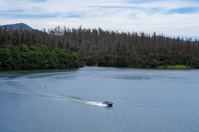 A boat crossing Pykara Lake in the Nilgiris near Ooty