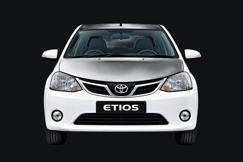 White Toyota Etios sedan from the B&B Tours and Travels fleet, front view